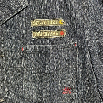 OutOf10 JNCO JEANS dark wash herringbone denim workwear jacket featuring military-style patches and chest pocket