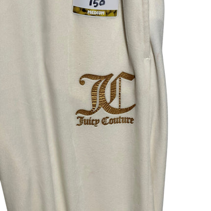 OutOf10 Juicy Couture cream velour jogger sweatpants featuring gold-tone embroidered logo detail on the hip.