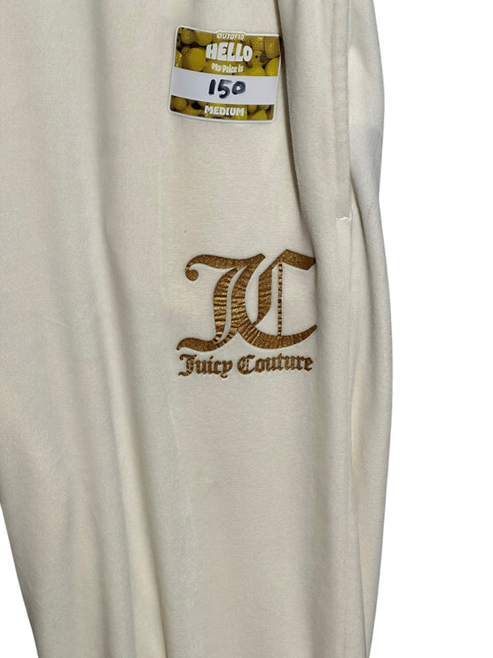 OutOf10 Juicy Couture cream velour jogger sweatpants featuring gold-tone embroidered logo detail on the hip.