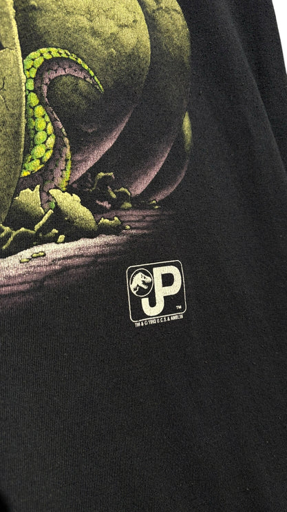 OutOf10 black crewneck t-shirt featuring a detailed green hatching dinosaur egg graphic and Jurassic Park logo print.