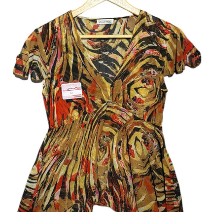 OutOf10 KAELY MAX short sleeve V-neck blouse featuring a vibrant abstract swirl print in earth tones and red.