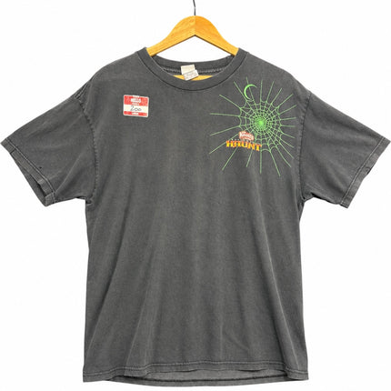 OutOf10 washed-black cotton t-shirt featuring a neon-green spiderweb graphic and Knott's Haunt logo on the front.
