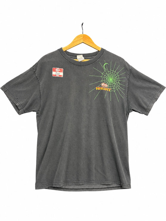 OutOf10 washed-black cotton t-shirt featuring a neon-green spiderweb graphic and Knott's Haunt logo on the front.