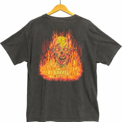 OutOf10 vintage washed-black cotton t-shirt featuring a vibrant fiery skull graphic on the back for Knott's Scary Farm.
