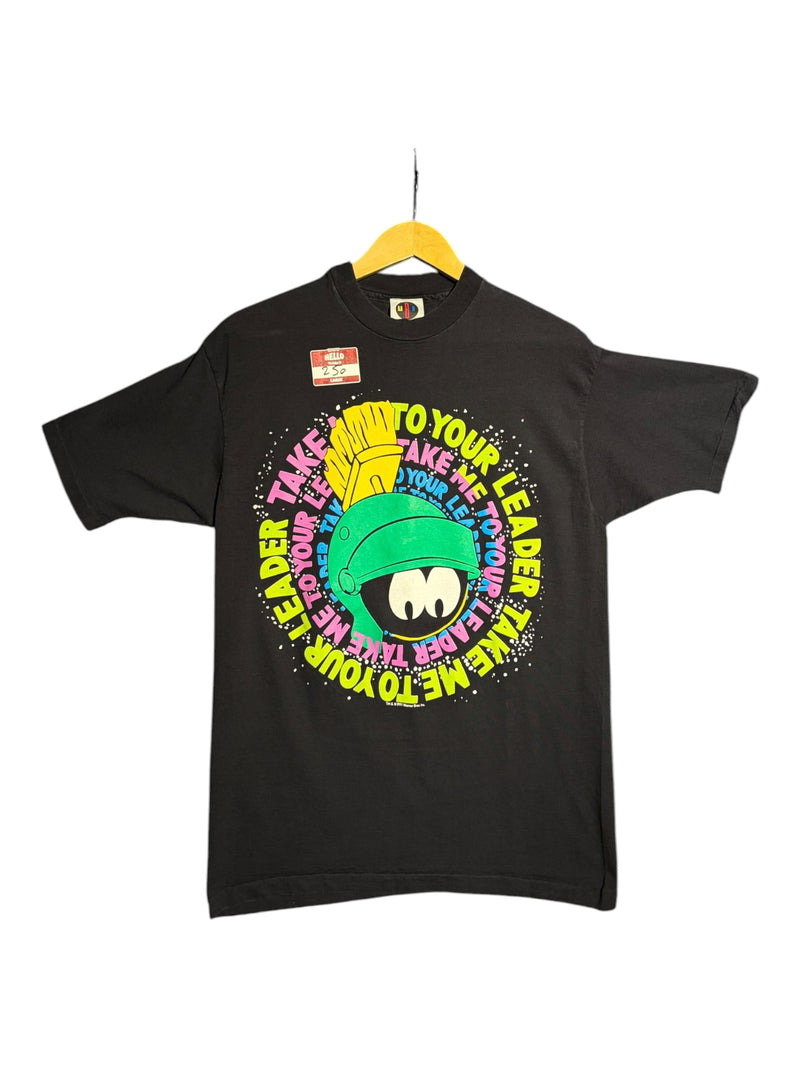 OutOf10 black crewneck t-shirt featuring a vibrant Marvin the Martian graphic with neon text on a hanger
