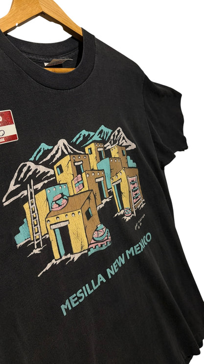 OutOf10 black short sleeve t-shirt featuring a vintage graphic of Mesilla New Mexico adobe buildings and mountains.