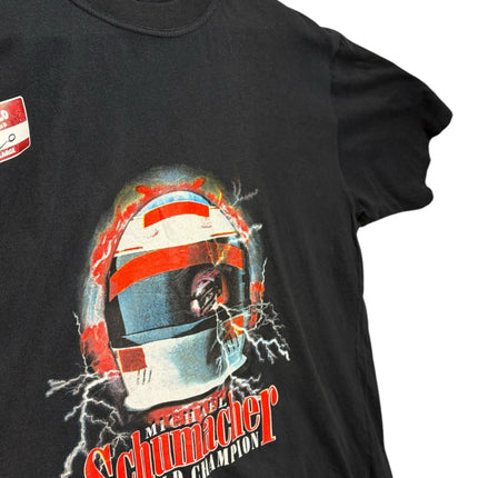 OutOf10 black cotton t-shirt featuring a Michael Schumacher racing helmet graphic with lightning and bold text.