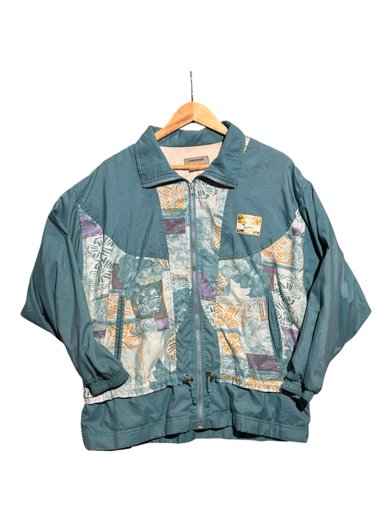 OutOf10 vintage Montval teal windbreaker jacket with abstract patterned panels, full-zip front, and drawstring hem.