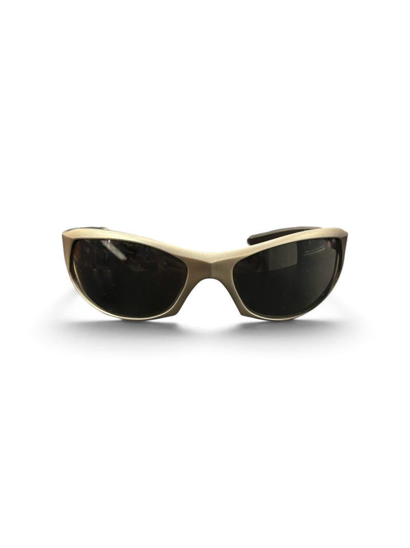 OutOf10 Mormaii performance wrap sunglasses featuring a matte gold frame and dark UV-protective lenses.