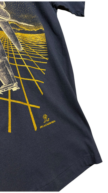 OutOf10 navy blue cotton t-shirt featuring a gold F/A-18 fighter jet graphic and Blackbird logo on the front