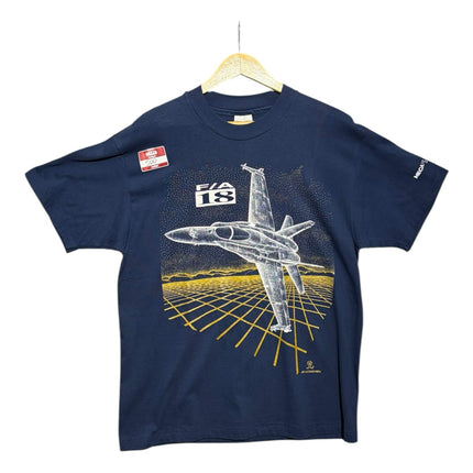 OutOf10 navy blue cotton t-shirt featuring a white F/A-18 fighter jet graphic over a golden grid landscape