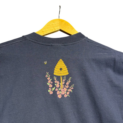 OutOf10 navy blue cotton t-shirt featuring a small beehive and floral graphic on the back