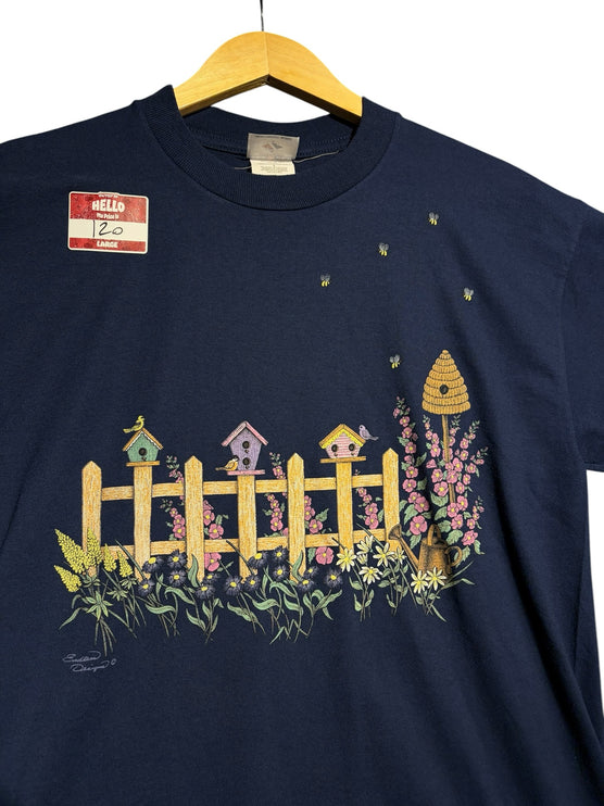 OutOf10 navy blue cotton t-shirt featuring a vintage garden graphic with birdhouses, flowers, and bees.