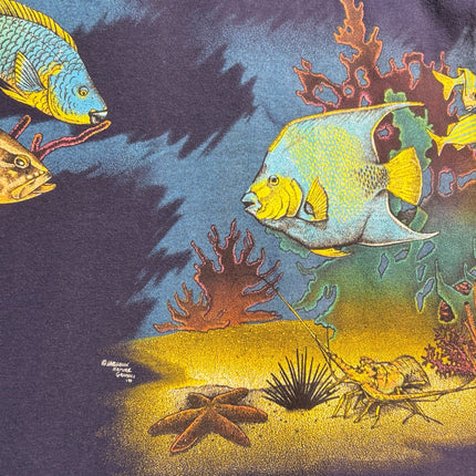 OutOf10 navy blue cotton t-shirt featuring a vibrant underwater scene with tropical fish, coral, and a sea turtle.