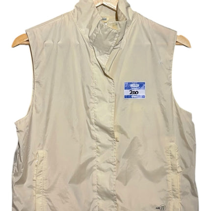 OutOf10 Nike cream sleeveless zip-up performance vest with high neck and side pockets on a wooden hanger