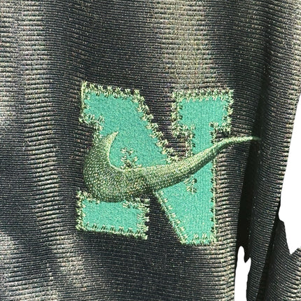 OutOf10 vintage Nike track jacket featuring a teal embroidered N logo with a green Swoosh on shimmering black fabric.