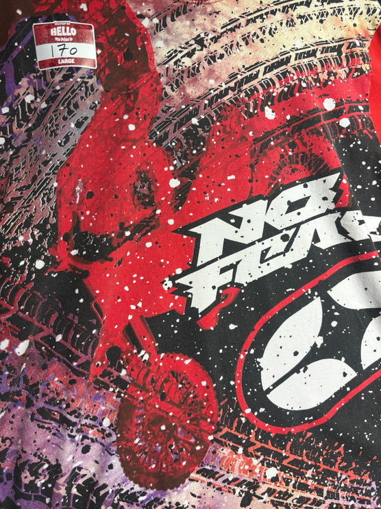 OutOf10 No Fear red graphic t-shirt with tire track motifs, paint splatter, and bold extreme sports branding