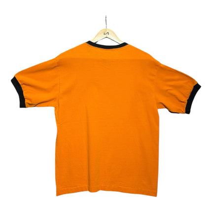 OutOf10 vintage-inspired orange ringer t-shirt with black crew neck and sleeve trim, back view on a wooden hanger.