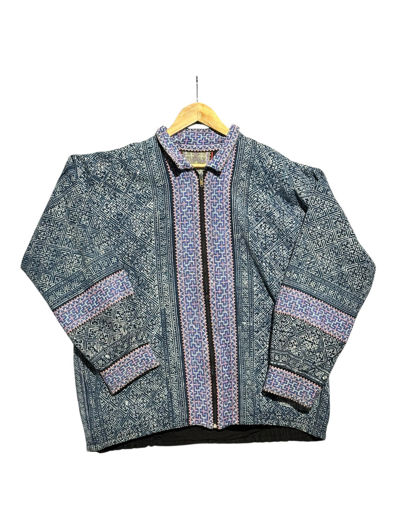 OutOf10 zip-up jacket featuring blue and lavender geometric heritage patterns on durable fabric with a classic collar.