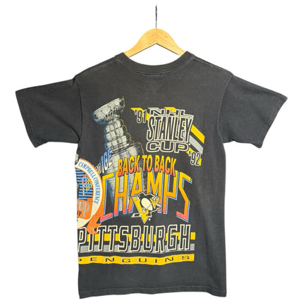 OutOf10 vintage black Pittsburgh Penguins back-to-back Stanley Cup championship graphic t-shirt on a wooden hanger.
