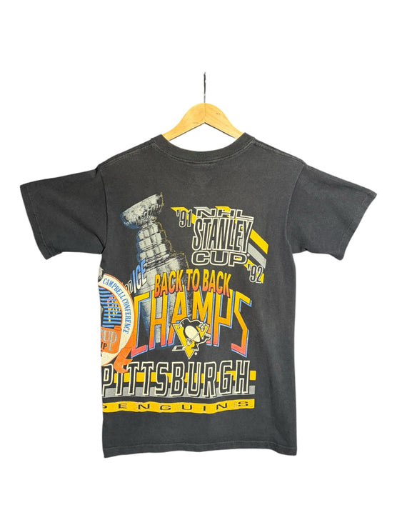 OutOf10 vintage black Pittsburgh Penguins back-to-back Stanley Cup championship graphic t-shirt on a wooden hanger.