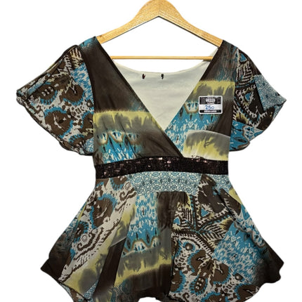 OutOf10 bohemian printed V-neck peplum blouse with flutter sleeves, sequin waist detail, and handkerchief hemline.