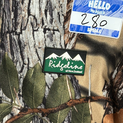 OutOf10 Ridgeline of New Zealand camouflage hunting jacket with branded mountain logo patch and price tag