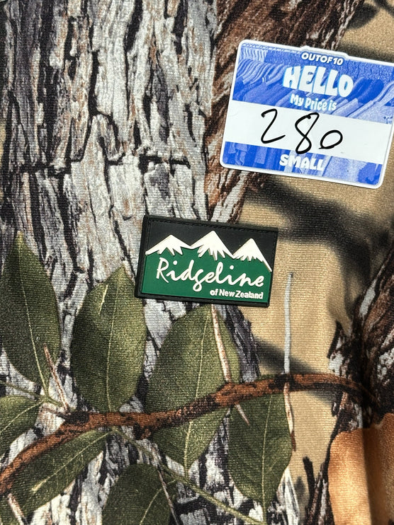 OutOf10 Ridgeline of New Zealand camouflage hunting jacket with branded mountain logo patch and price tag