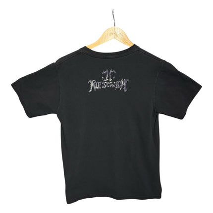 OutOf10 black cotton crewneck t-shirt featuring a distressed Rorschach logo on the back, hanging on a wooden hanger.