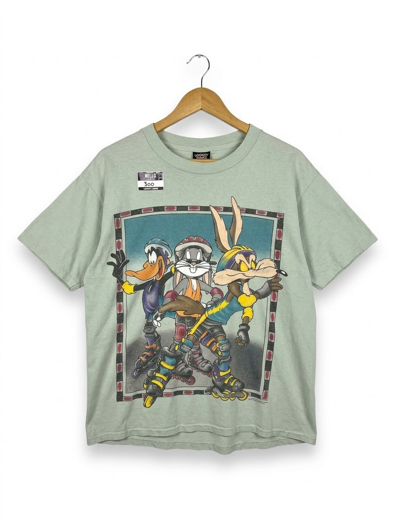 OutOf10 sage green Looney Tunes graphic t-shirt featuring Bugs Bunny, Daffy Duck, and Wile E. Coyote rollerblading.