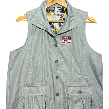 OutOf10 sage green quilted utility vest with button front, flap pockets, and floral interior lining on a hanger.