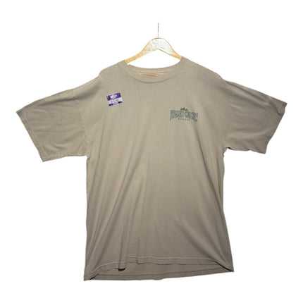 OutOf10 sand-toned cotton short sleeve t-shirt with a small Aloha Island Magic chest logo on a wooden hanger.