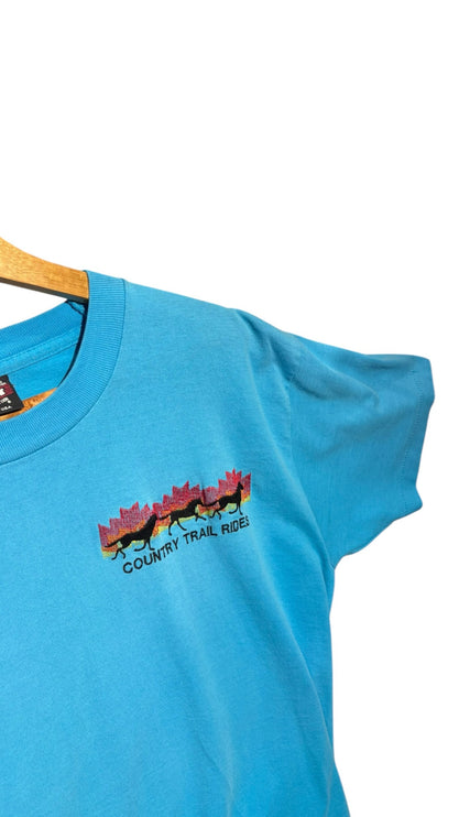 OutOf10 sky blue short sleeve t-shirt featuring a vintage Country Trail Rides horse graphic with a sunset maple leaf