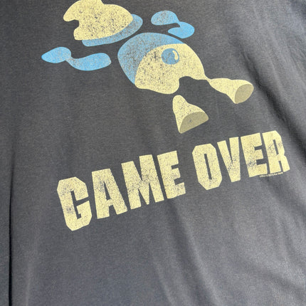 OutOf10 slate-blue cotton t-shirt featuring a distressed retro Game Over graphic print with a vintage gaming character.