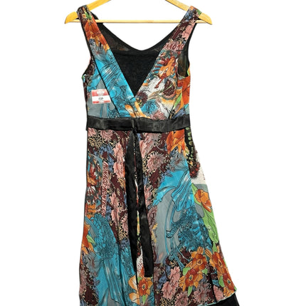 OutOf10 sleeveless floral print dress with a V-neckline, black satin waist tie, and vibrant botanical pattern.