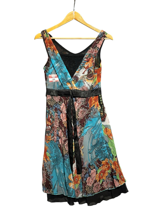 OutOf10 sleeveless floral print dress with a V-neckline, black satin waist tie, and vibrant botanical pattern.