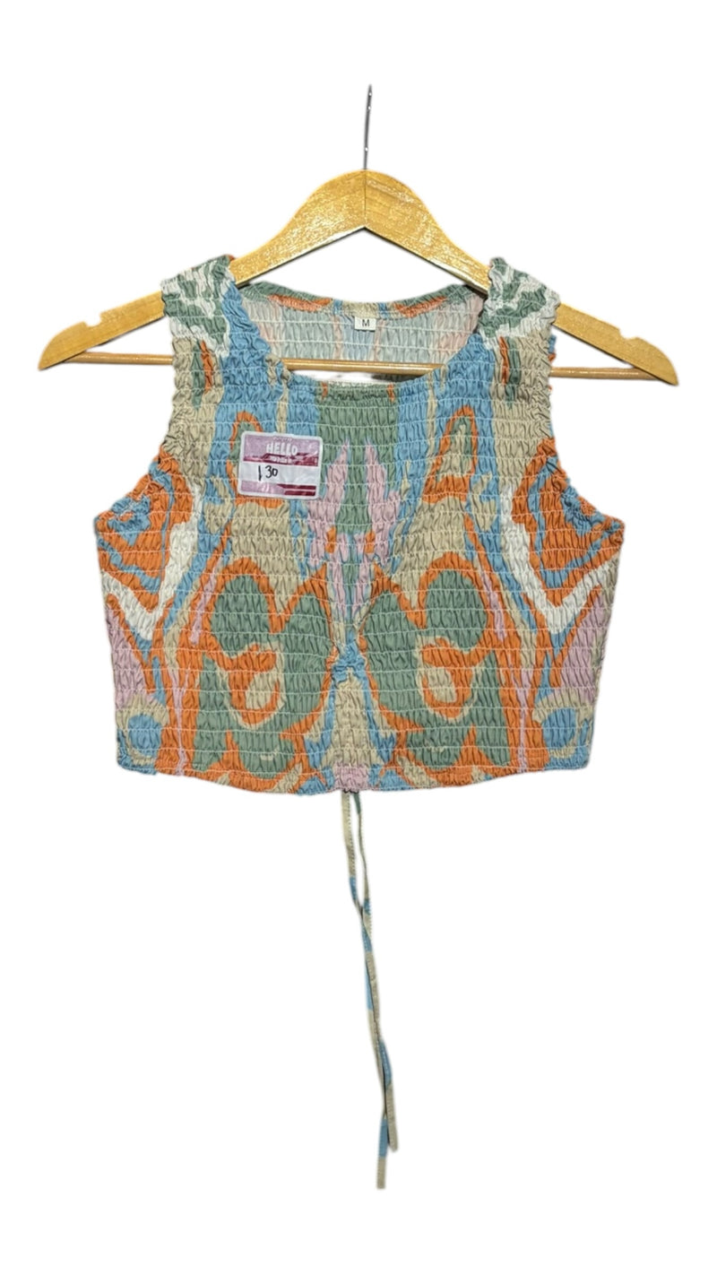 OutOf10 sleeveless smocked crop top with a multi-coloured abstract print, high neck, and adjustable tie-hem detail.