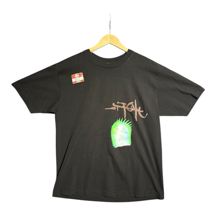 OutOf10 black Stussy cotton t-shirt with a hand-drawn logo and vibrant neon green graphic print on the front.