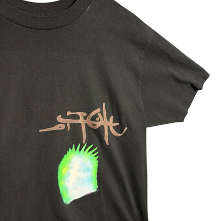 OutOf10 black cotton Stussy t-shirt featuring a hand-drawn logo and vibrant neon green graphic detail on the front