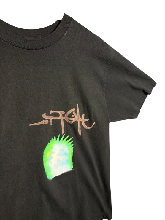 OutOf10 black cotton Stussy t-shirt featuring a hand-drawn logo and vibrant neon green graphic detail on the front