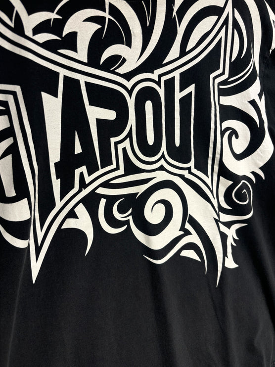 OutOf10 black cotton t-shirt featuring a large white tribal-inspired Tapout logo graphic print on the chest