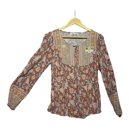 OutOf10 bohemian long-sleeve blouse in terracotta with blue and sage floral print, tie-front neckline, and cuffs.