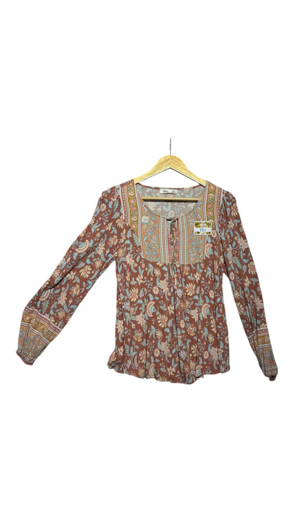 OutOf10 bohemian long-sleeve blouse in terracotta with blue and sage floral print, tie-front neckline, and cuffs.