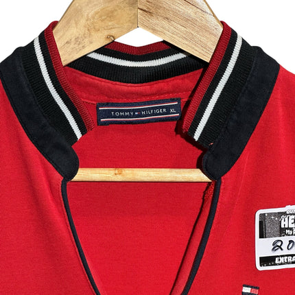 OutOf10 Tommy Hilfiger sleeveless red polo dress with a V-neckline and striped ribbed collar on a wooden hanger.