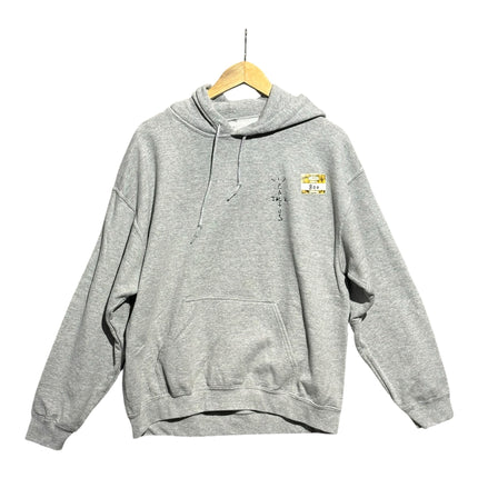 OutOf10 grey Travis Scott Cactus Jack Astronomical hoodie with front logo and drawstring hood on a wooden hanger