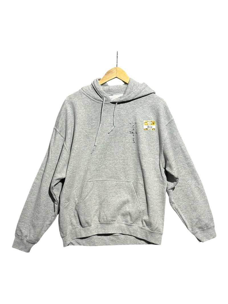 OutOf10 grey Travis Scott Cactus Jack Astronomical hoodie with front logo and drawstring hood on a wooden hanger