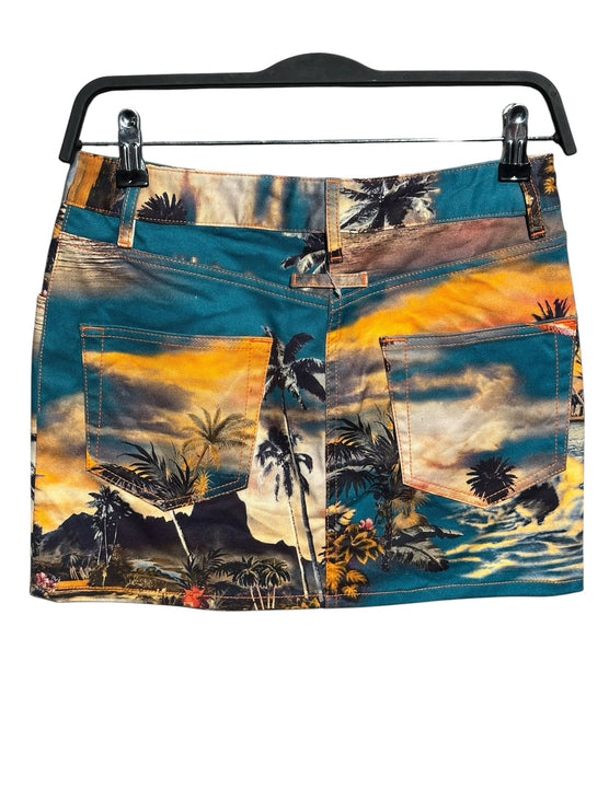 OutOf10 denim mini skirt featuring a vibrant tropical sunset landscape print with palm trees in teal and orange tones.