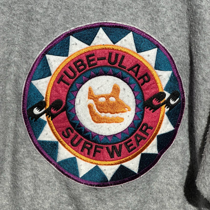 OutOf10 TUBE-ULAR SURFWEAR vintage circular embroidered logo patch on a heather grey fleece pullover