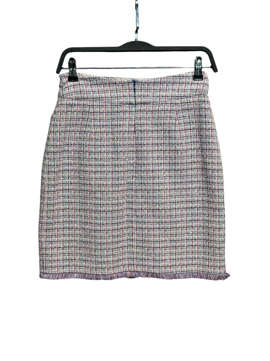OutOf10 textured tweed mini skirt in pink, navy, and cream check pattern with a frayed hemline on a hanger.