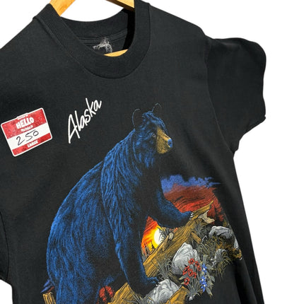 OutOf10 black cotton t-shirt featuring a vintage Alaska bear graphic with a sunset landscape on a wooden hanger